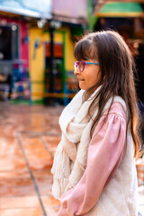 Beautiful Latin girl with scarf and jacket enjoying her vacation in Colombia. Trips and excursions, people smiling. Children's day. 