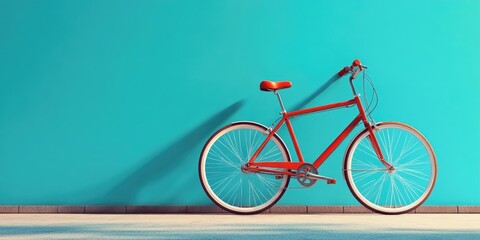 Fototapeta premium Red bicycle propped against a blue-colored wall, leaning to the left. Minimalistic interior design with a focus on simplicity and vintage style.