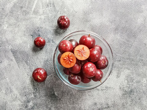 Flacourtia fruit in a bowl. Rukam, ramontchi, governor's plum, Indian plum, and Indian prune. Bowl of fruits. 