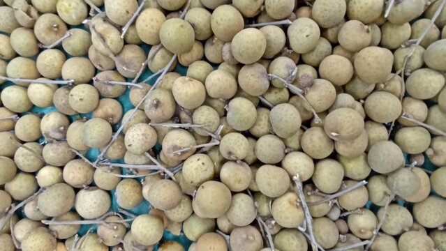Longan Fruit Displayed Freshly on Traditional Market Stand