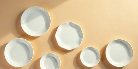 Sunlight Illuminates a Collection of Simple White Dishes on a Warm Background