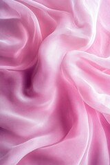 Obraz premium Pink fabric with a wave pattern. The fabric is soft and smooth to the touch. The color pink is dominant throughout the image, giving it a feminine and elegant feel