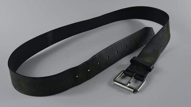 Black Leather Belt Strap Against White Backdrop, Menswear Studio Shot