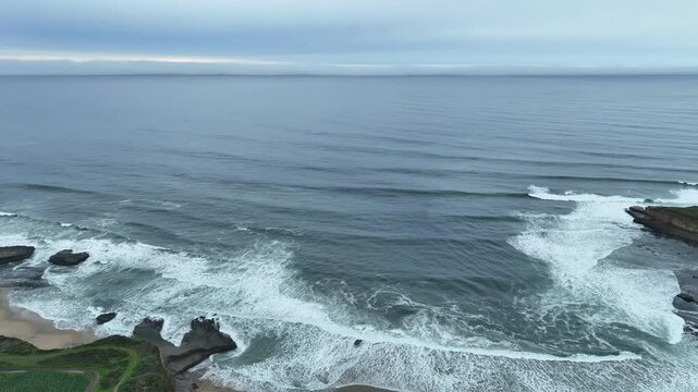 Pacific Ocean waves roll onto the scenic coastline just north of Santa Cruz, California. This beautiful region of Northern California is known for its quality surfing waves.