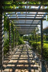 Winding stone walkway under wooden pergola with trellis and grapevines.