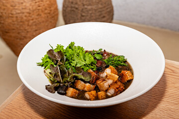 gourmet preparation of delicious bean soup with Colombian pork rinds and two types of lettuces