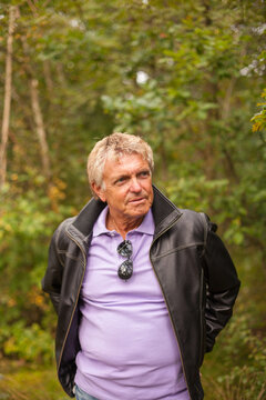 A portrait of a senior man outside in the Swedish nature