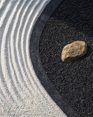 Fototapeta premium Zen garden with sand and a solitary stone.