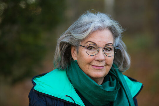 A portrait of a Swedish senior woman outside in the nature