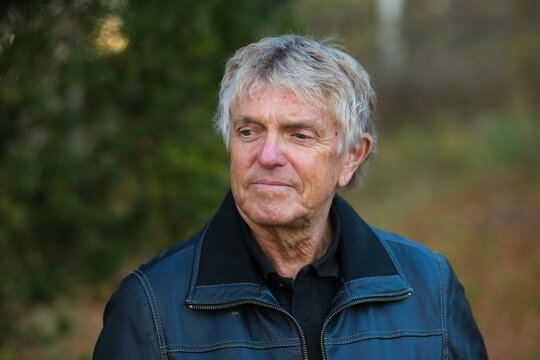 A portrait of a Swedish senior man outside in nature