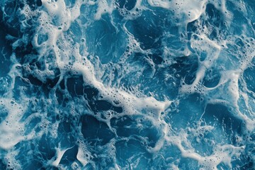 Naklejka premium Close-Up of the Surface Texture of Blue Water with Waves and Foam Captured in High Resolution