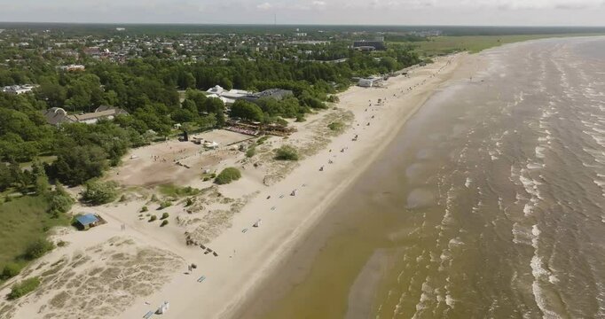 Aerial overview backward over the Parnu beach, sunny, summer day in Estonia