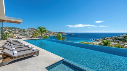Obraz premium Panoramic scene of a beachfront infinity pool, surrounded by inviting chaise lounges and offering stunning views of the endless ocean under clear skies