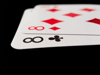 Two playing cards with the number 8 on them