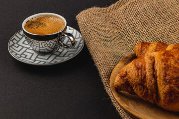 Freshly Baked Croissants and a Cup of Espresso on a Beautiful Dark Background