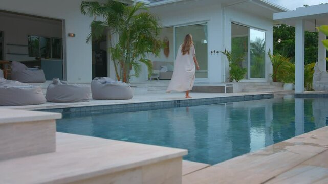 Enjoy a serene evening by the pool in a stunning modern luxury villa, ideal for relaxation