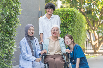 portrait senior woman cancer patient on wheelchair,family,health care workers supporting,talking and empowering while resting outdoors in hospital