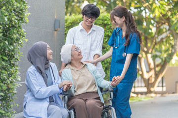 senior woman cancer patient on wheelchair,family,health care workers supporting,talking and empowering while resting outdoors in hospital