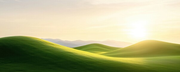Obraz premium A serene landscape featuring gentle green hills illuminated by a soft sunrise, creating a peaceful and refreshing atmosphere.