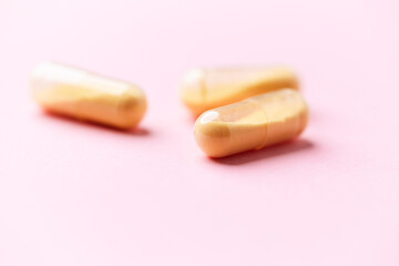 Coenzyme Q10 capsules. Antioxidants. Concept for a healthy dietary supplementation. Bright paper background. Soft focus. Close up. Copy space.