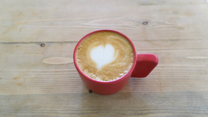 A cup of hot latte coffee on the table for breakfast
