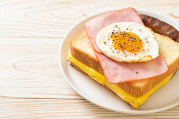bread toasted cheese topped ham and fried egg with pork sausage