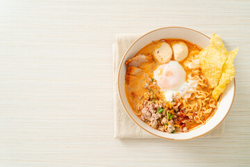 instant noodles with pork and meatballs in spicy soup