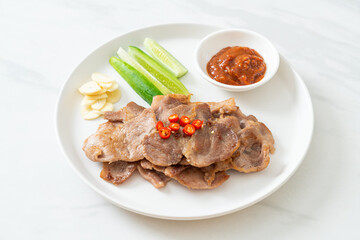 grilled pork neck sliced on plate