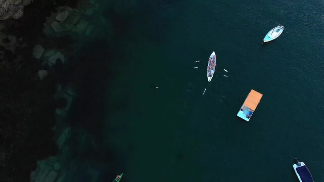 Drone shot, rowers in rowboat, water sports, Australia, beach, Sydney, Northern Beaches, Little, Manly, Harbour, dark blue, team sport, slow motion, hard work, rowing hard, intense sport, birds eye vi