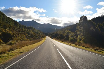 Fototapeta premium Sunny road through mountain valley.