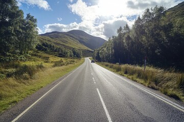 Scenic highway road trip through green hills and mountains under a bright sunny sky.
