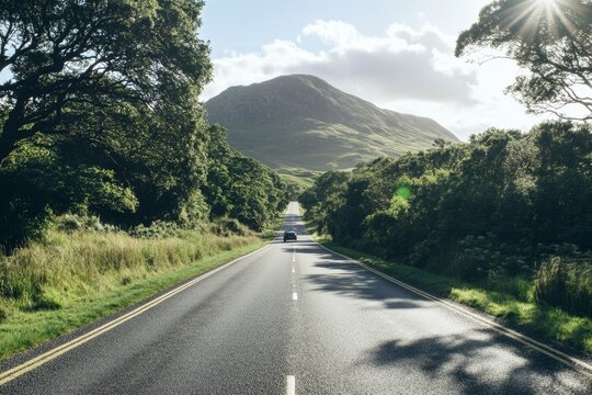 Scenic highway road trip through lush green landscape with mountains.