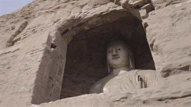 The Yungang Grottoes in Datong, Shanxi, China, were originally built 1500 years ago during the Northern Wei Dynasty. They are huge and exquisite stone carvings of Buddha statues in ancient China