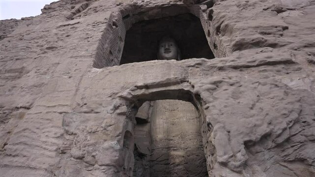 The Yungang Grottoes in Datong, Shanxi, China, were originally built 1500 years ago during the Northern Wei Dynasty. They are huge and exquisite stone carvings of Buddha statues in ancient China