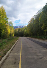 paved highway in a mountainous area in early autumn with panoramic views