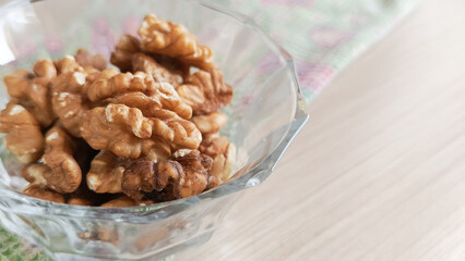 Walnuts in a transparent cup. Minerals and vitamins in nuts. Soaking nuts in water before eating. 
