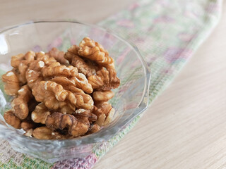 Walnuts in a transparent cup. Minerals and vitamins in nuts. Soaking nuts in water before eating. 
