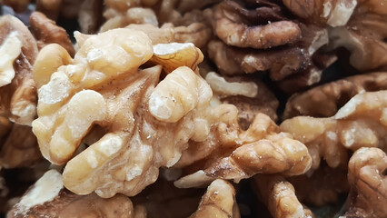A bunch of walnuts in close-up. Júglans régia. Fruits of a tree of the Juglandaceae family.