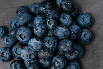 Close-up of blueberries on dark background.Fresh Blueberry Bounty. Close-up of ripe juicy blueberries filling the frame