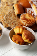 Freshly baked sweet pastries and cookies on display in a cozy setting with a warm ambiance