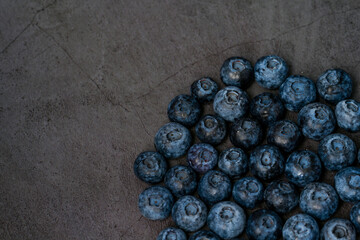 Close-up of blueberries on dark background.Fresh Blueberry Bounty. Close-up of ripe juicy blueberries filling the frame