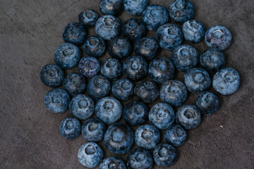Close-up of blueberries on dark background.Fresh Blueberry Bounty. Close-up of ripe juicy blueberries filling the frame