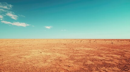 Fototapeta premium Vast Desert Landscape Under Clear Blue Sky with Cloud Patterns
