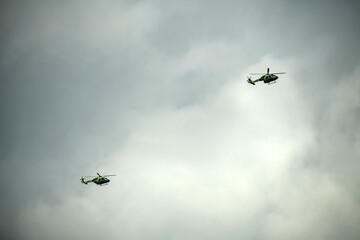 Helicopter is flying on isolated overcast mid-air sky