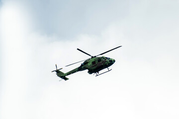 Helicopter is flying on isolated overcast mid-air sky
