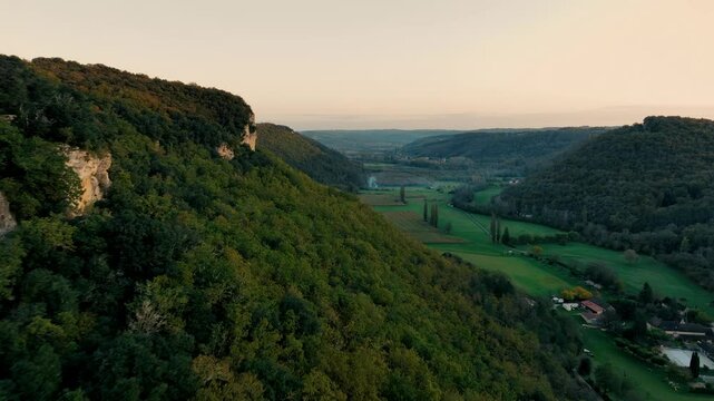 Drone shot over a forest with cliffs at sunset.fast, ground-level shot in ceou valley near Sarlat in Dordogne