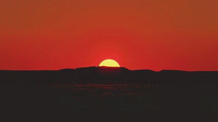 Fototapeta premium Vibrant Sunset Over Silhouette Horizon in Warm Orange Tones