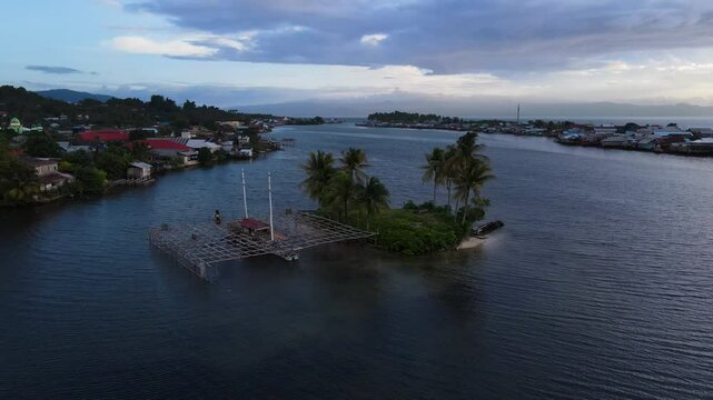 A Picturesque View of a Fishing Village at Dusk, Tucked Along the Coast of Sulawesi, Indonesia - Orbit Drone Shot