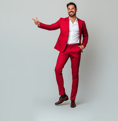 A professional man wearing a red blazer and white shirt, smiling confidently, pointing with her right hand outward to the side as if indicating a message or text.