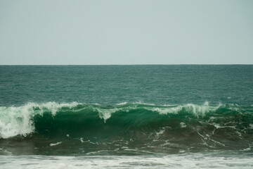 waves breaking on the beach. Ocean waves breaking on a  beach. Close up shot of breaking wave Pandansari beach, Central Java, Indonesia.